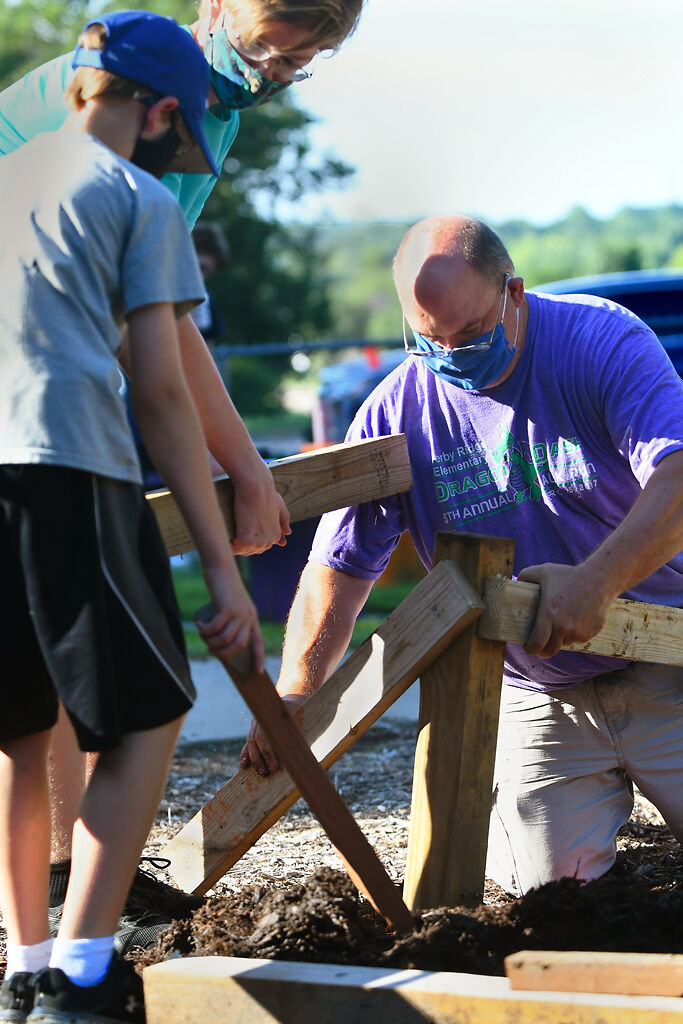 Doug Shinn, on the right, assembles the various wood blocks together into balance